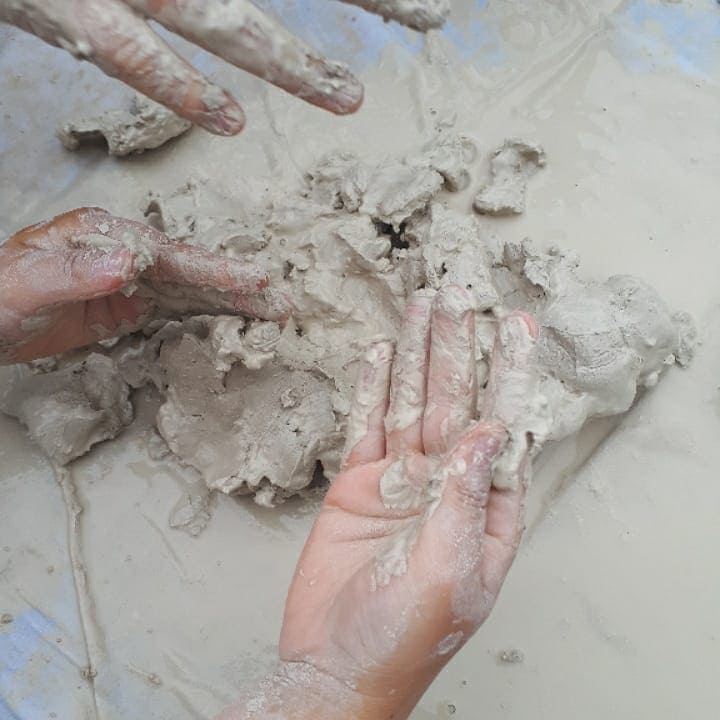 a hands and mud on a surface